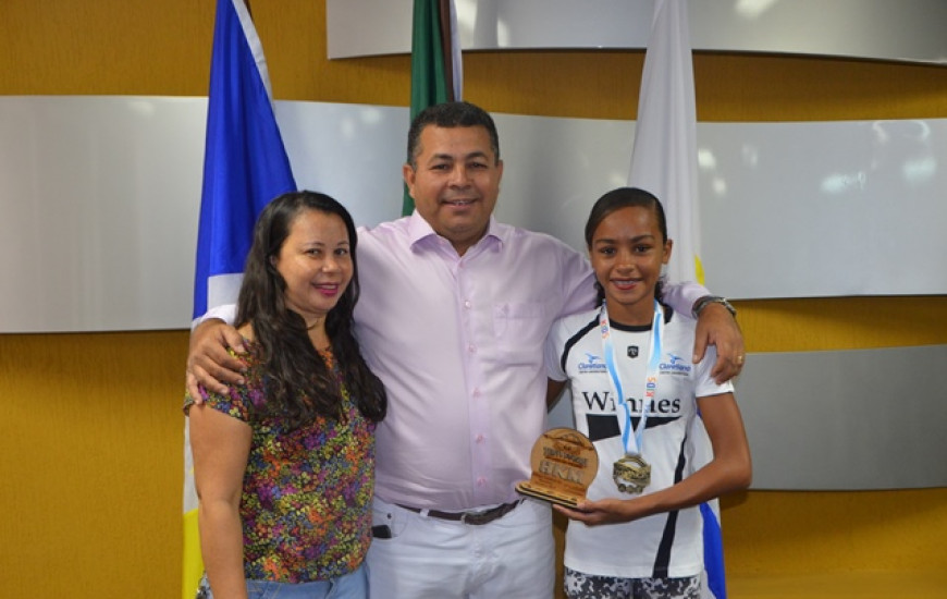Mãe e filha posam ao lado do vereador que tem apoiado menina no esporte